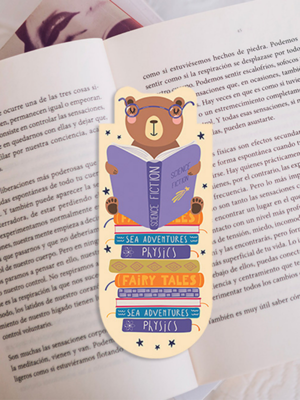 zakładka magnetyczna z misiem na górze książek który czyta