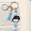 zawieszka bag charm breloczek do kluczy zawieszka do torebki kot i książki w kolorze srebrnym i niebieskim prezent dla miłośnika kotów i książek