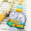 kot w okularach na książkach - bag charm dla miłośniczki kotów i książek breloczek z kotem i książkami